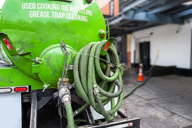 a professional service truck pumping a grease trap in Argenta